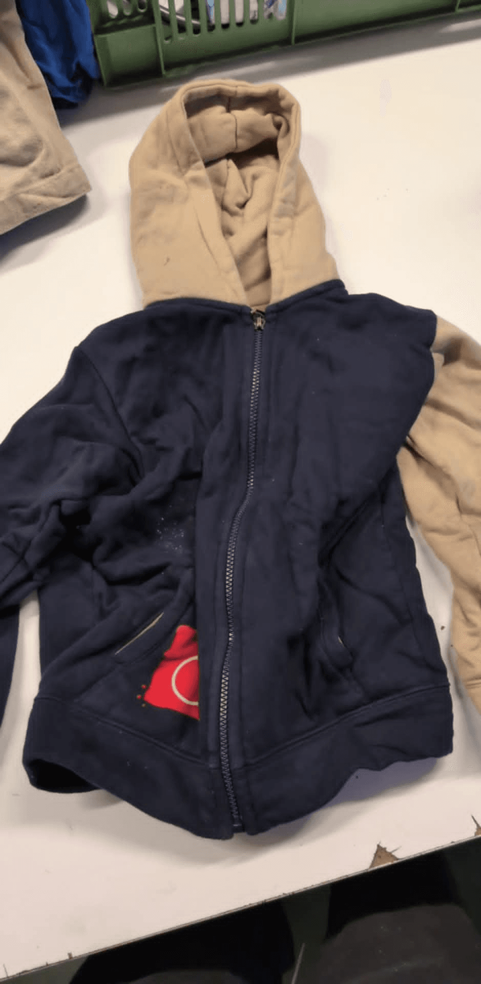 a blue and tan hoodie with the letter c on it