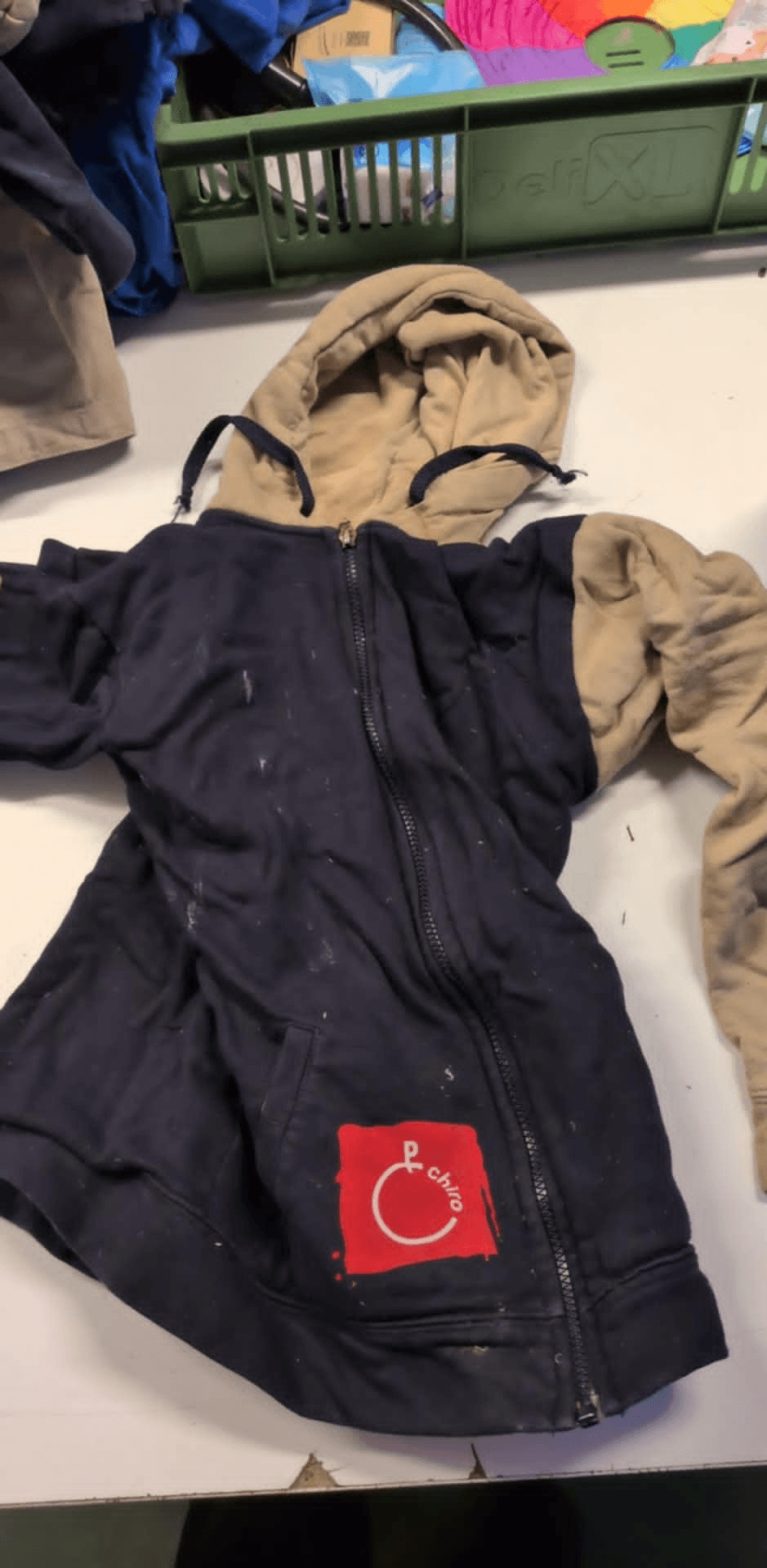 a blue and tan jacket with a red patch that says clown on it