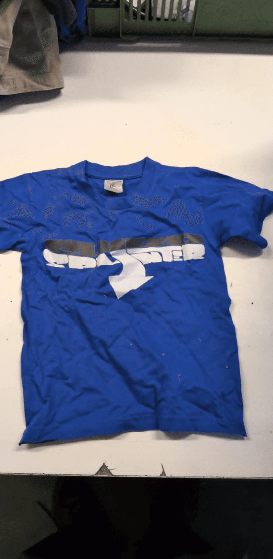 a blue shirt with the letter s on it