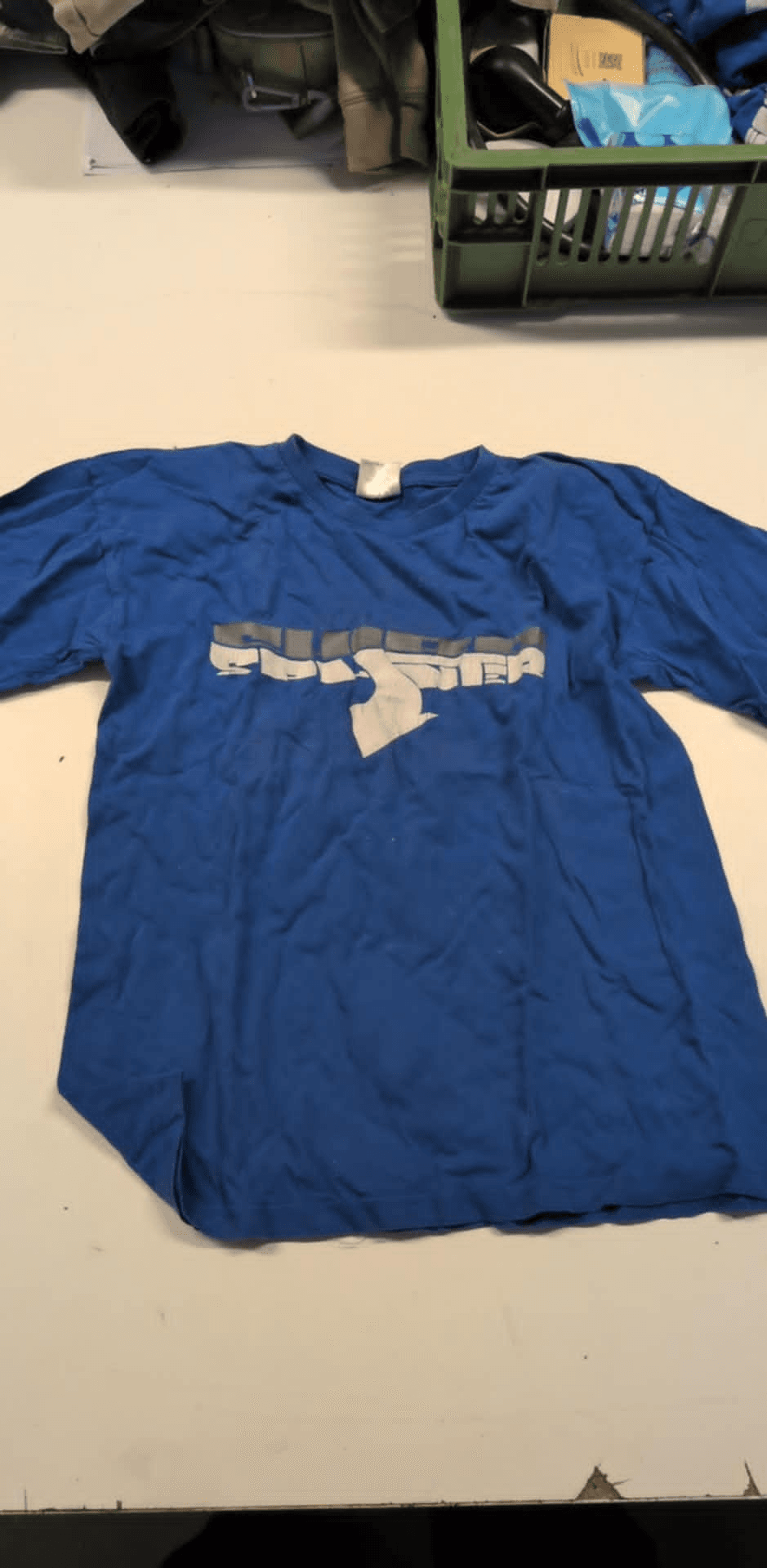 a blue t-shirt with a white letter s on it