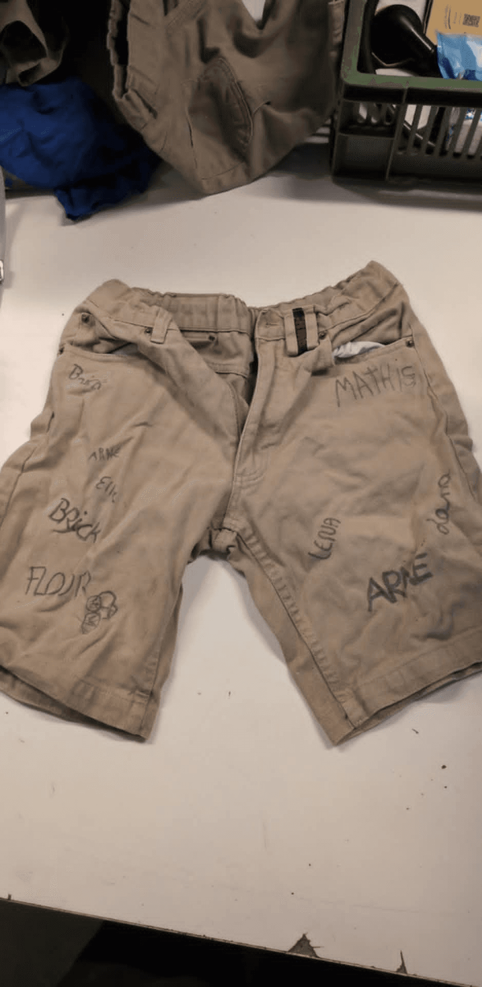 a pair of khaki shorts with the word matheus written on them